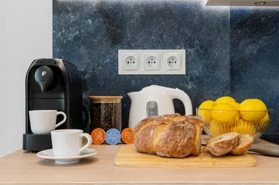 a table topped with a loaf of bread and coffee cups at Czarnowiejska Micro Studio in Kraków