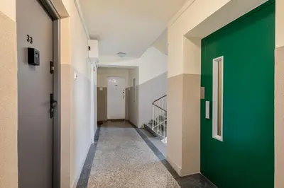 a hallway with a green door in a building at Czarnowiejska Micro Studio in Kraków