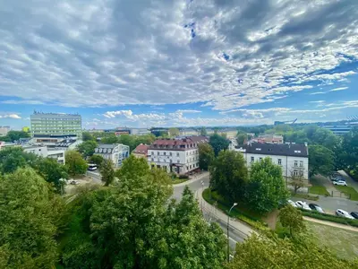 a city with buildings and cars on a road at Czarnowiejska Micro Studio in Kraków