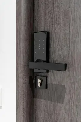 a black door with a cup on it at Czarnowiejska Micro Studio in Kraków