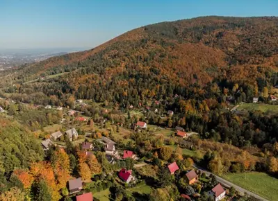 an aerial view of a small village on a hill at Beskidzka Oaza in Targanice