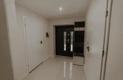 a room with white walls and a kitchen with a door at Beskidzka Oaza in Targanice