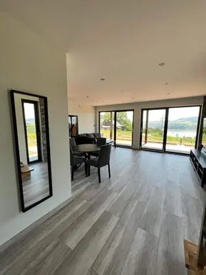 a large living room with a table and a piano at Wichrowe Wzgórze z jacuzzi in Znamirowice