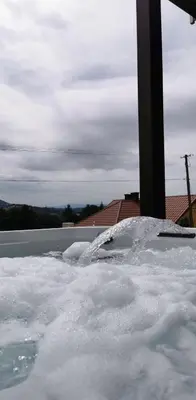 a car covered in snow next to a pole at Wichrowe Wzgórze z jacuzzi in Znamirowice