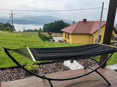 a hammock sitting on top of a house at Wichrowe Wzgórze z jacuzzi in Znamirowice