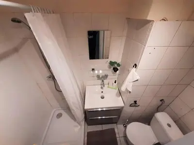 a small bathroom with a sink and a toilet at Baza wypadowa Kraków Kazimierz in Kraków