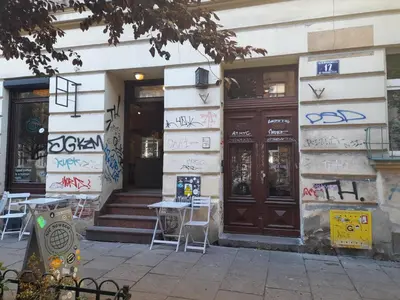 a building with graffiti on the side of it at Baza wypadowa Kraków Kazimierz in Kraków