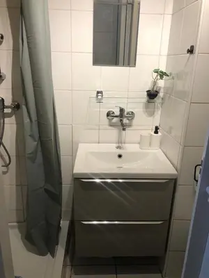 a bathroom with a sink and a shower at Baza wypadowa Kraków Kazimierz in Kraków