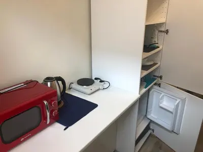 a kitchen counter with a red microwave and a toaster at Baza wypadowa Kraków Kazimierz in Kraków