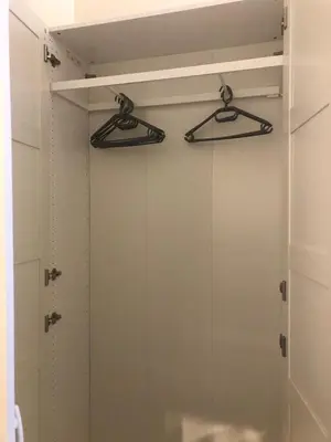 a glass shower door with two hangers in a bathroom at Baza wypadowa Kraków Kazimierz in Kraków