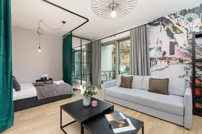 a living room with a couch and a table at Kraków Rynek Podgórski Apartment by Noclegi Renters in Kraków