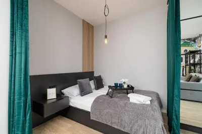a bedroom with a bed and a table at Kraków Rynek Podgórski Apartment by Noclegi Renters in Kraków