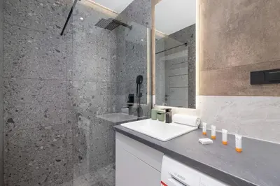 a bathroom with a sink and a shower at Kraków Rynek Podgórski Apartment by Noclegi Renters in Kraków