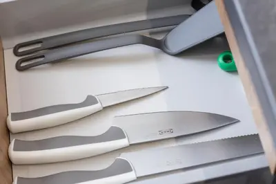 a group of knives sitting on top of a drawer at Kraków Rynek Podgórski Apartment by Noclegi Renters in Kraków