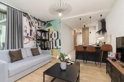 a living room with a couch and a table at Kraków Rynek Podgórski Apartment by Noclegi Renters in Kraków