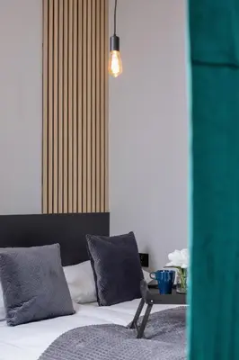 a bedroom with a bed and a table with pillows at Kraków Rynek Podgórski Apartment by Noclegi Renters in Kraków