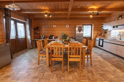 a dining room with a table and chairs in a kitchen at Agroturystyka Góra Fiedora in Pieniążkowice