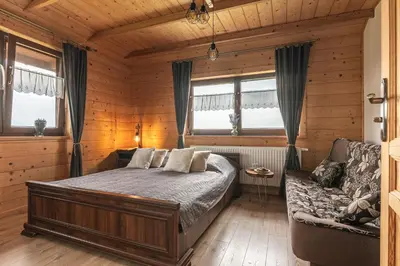 a bedroom with a bed and a couch at Agroturystyka Góra Fiedora in Pieniążkowice