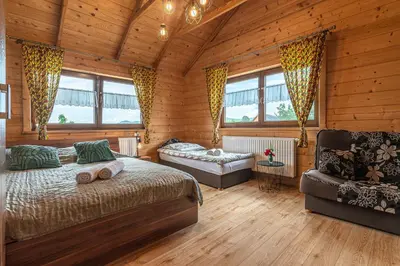 a bedroom with a bed and a couch in a room at Agroturystyka Góra Fiedora in Pieniążkowice