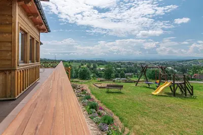 a porch with a bench and a playground at Agroturystyka Góra Fiedora in Pieniążkowice