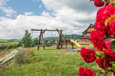 a park with a playground and a swing at Agroturystyka Góra Fiedora in Pieniążkowice