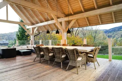 a patio with a table and chairs on a deck at Willa Sonia Zawoja in Zawoja