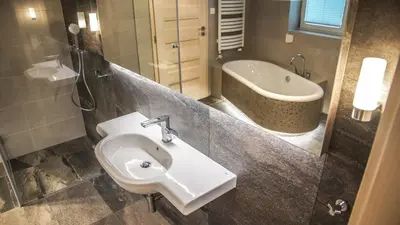 a bathroom with a sink and a bath tub at Willa Sonia Zawoja in Zawoja