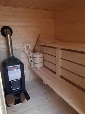 a inside of a sauna with a wood stove at Domek w górach pod Jodłami in Nowy Targ