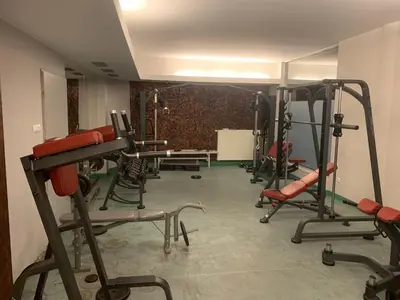 a gym with several exercise equipment in a room at City view Wellness Apartment swim&steam&relax in Kraków