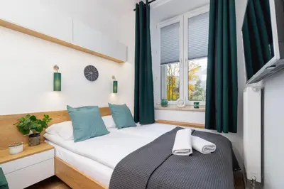 a bedroom with a bed and a window at Kraków Trendy Studio Apartments by Noclegi Renters in Kraków