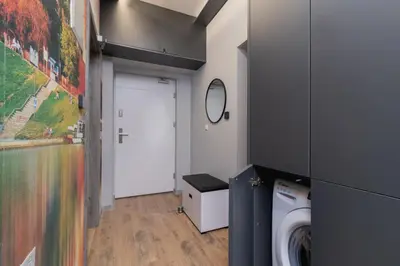 a laundry room with a washing machine and a door at Kraków Trendy Studio Apartments by Noclegi Renters in Kraków