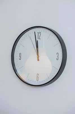 a clock is hanging on a white wall at Kraków Trendy Studio Apartments by Noclegi Renters in Kraków