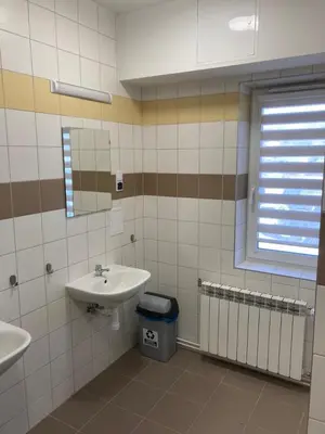 a bathroom with a sink and a mirror at Hostel przy Stadionie in Jaworzno