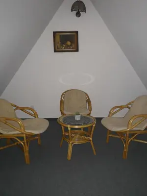 a room with three chairs and a table and a table and chairs at Noclegi Hexe in Żegocina