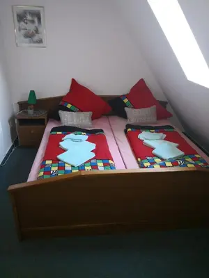 a bedroom with a bed with twopillows on it at Noclegi Hexe in Żegocina