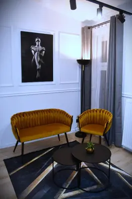 a living room with two chairs and a table at M-Keys Apartments Kraków Old Town Kazimierz in Kraków
