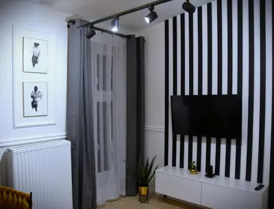 a living room with a flat screen tv on a wall at M-Keys Apartments Kraków Old Town Kazimierz in Kraków