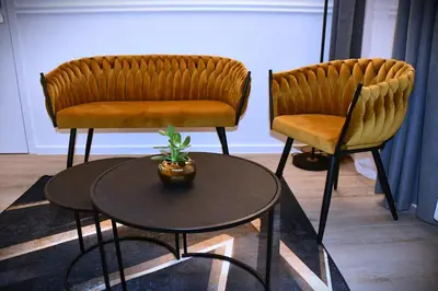 two chairs and a table with a plant on it at M-Keys Apartments Kraków Old Town Kazimierz in Kraków