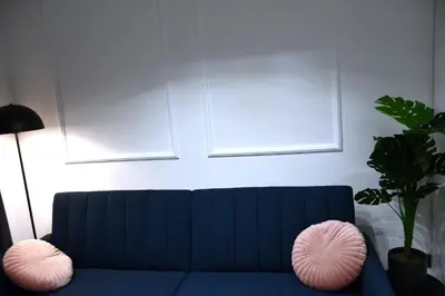 a blue couch with pink pillows in a living room at M-Keys Apartments Kraków Old Town Kazimierz in Kraków