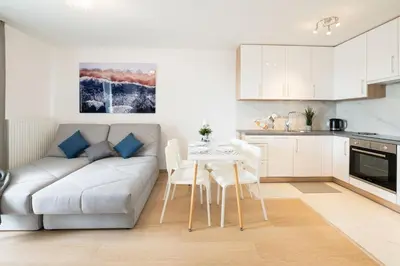 a living room with a couch and a table at Sołtysowska Apartment in Kraków