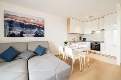 a living room with a couch and a table at Sołtysowska Apartment in Kraków