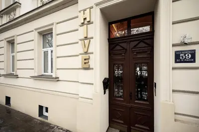 a door to a building with a sign on it at Hive Family House in Kraków