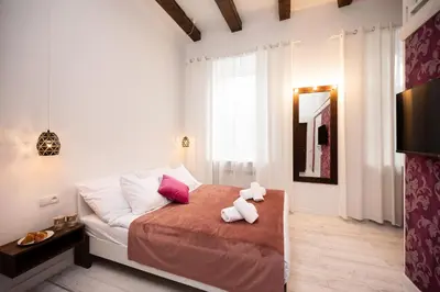 a bedroom with a bed with two teddy bears on it at Hive Family House in Kraków