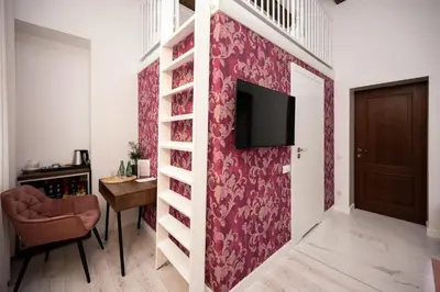 a living room with a wall with a tv on it at Hive Family House in Kraków