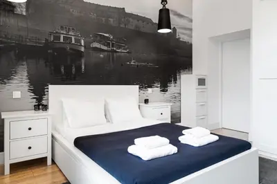 a bedroom with a large bed with towels on it at Househost Apartment: Bonerowska 5/19 in Kraków