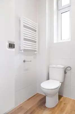 a white bathroom with a toilet and a window at Househost Apartment: Bonerowska 5/19 in Kraków