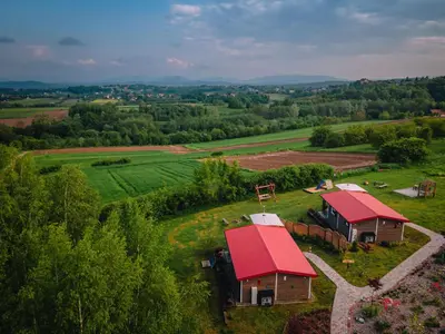 an aerial view of a farm with a red roof at Domki na Górniej Łące - Dwa Wróble in Łazany