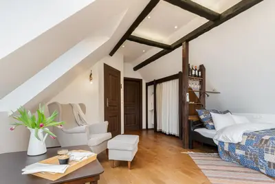a living room with a bed and a couch at Apartament Podskalański in Szyce