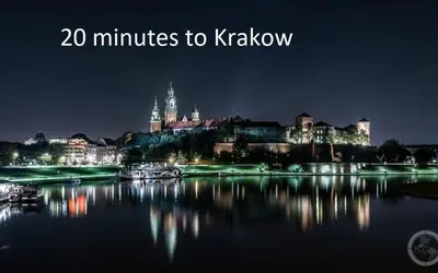 a view of a city at night with the words minutes to krakow at Apartament Podskalański in Szyce