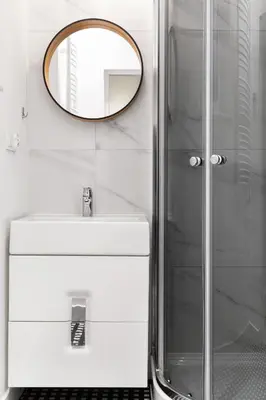 a bathroom with a sink and a mirror at Househost Apartment: Bonerowska 5/15 in Kraków